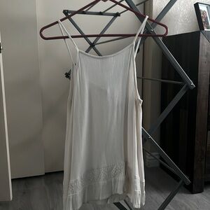 cream colored spaghetti strap shirt